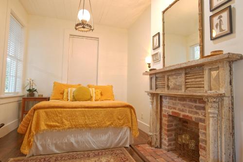 a bedroom with a bed and a fireplace at 1864 Little Brick - 1 Bed, 1 Bath, Full Kitchen, Pet Friendly with fee, Washer & Dryer in Natchez