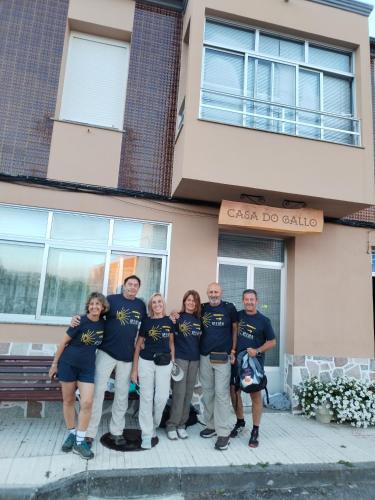 a group of people standing in front of a building at Pensión Casa do Gallo Sarria in Sarria