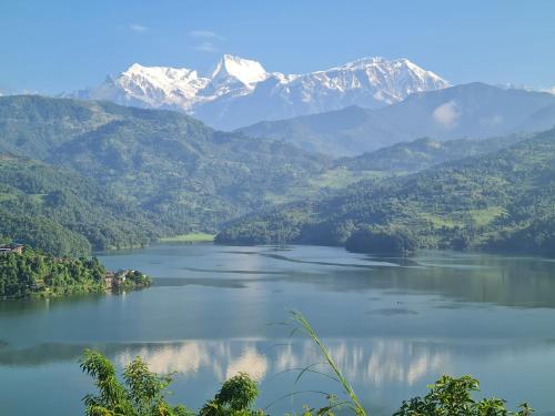 a view of a lake with mountains in the background at Mount Fuji Homestay in Deorāli