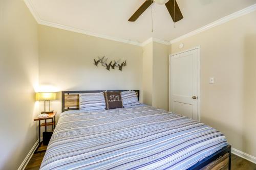 a bedroom with a bed with a blue and white striped comforter at Updated New Bern Home Less Than 3 Mi to Historic Dtwn! in New Bern