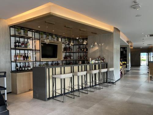 a bar with stools and a television in a room at Triann Condo Staycation Davao in Aeon Towers in Davao City