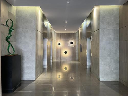 a hallway of a building with a sculpture on the floor at Triann Condo Staycation Davao in Aeon Towers in Davao City