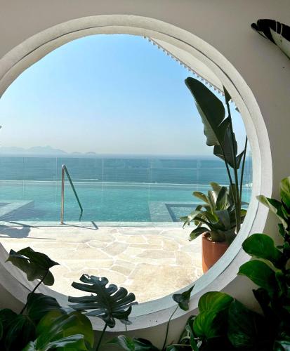 a view of a swimming pool through a window at Rio Othon Palace in Rio de Janeiro