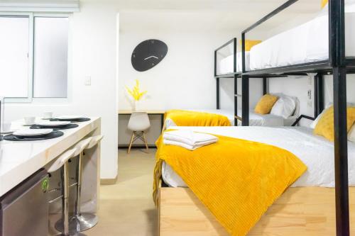 a bedroom with two bunk beds and a kitchen at Modern and Comfortable First Level Family Apt 4 in El Rodeo