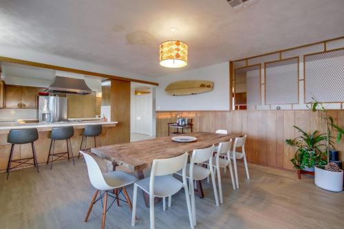 a large kitchen with a wooden table and chairs at Red Hawk Coastal Estate in San Diego