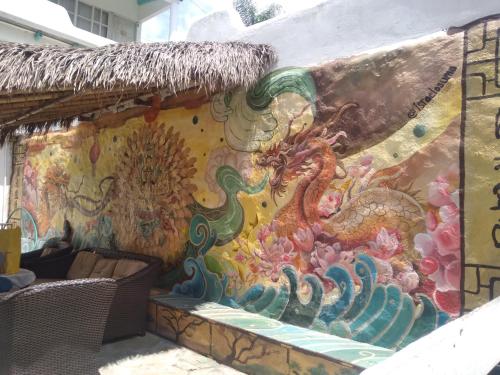 a wall with a painting of a dragon on it at Jardin Zen in Tepoztlán