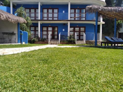 a blue house with a lawn in front of it at Jardin Zen in Tepoztlán