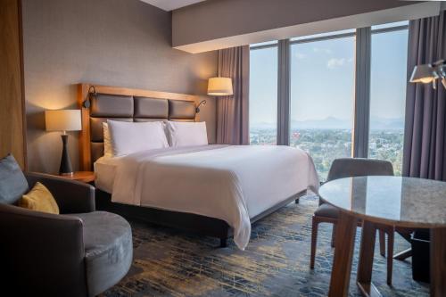 a hotel room with a bed and a table at Fiesta Americana Viaducto Aeropuerto in Mexico City