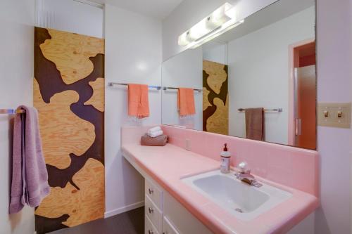 a bathroom with a pink sink and a mirror at Red Hawk Coastal Estate in San Diego