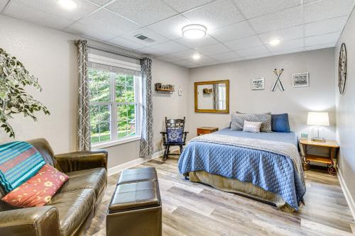 a bedroom with a bed and a couch at Hiawassee Hideaway Hot Tub, Lake and Mountain Views in Hiawassee