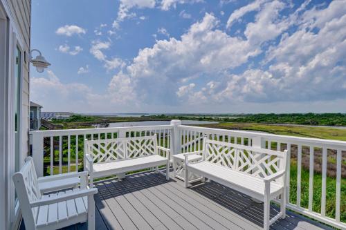 a balcony with two white benches on a white fence at Sea Haven by Sea Scape Properties in North Topsail Beach