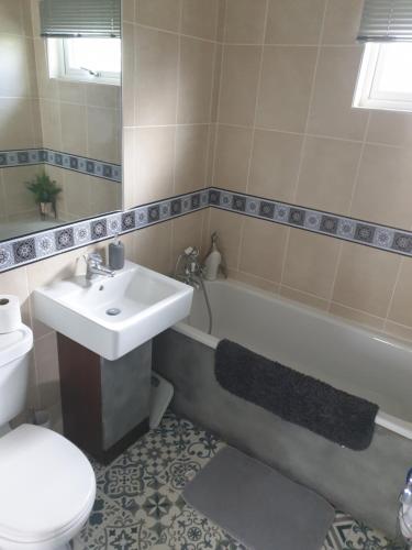 a bathroom with a sink and a tub and a toilet at Unique 2 bed lodge in Rhyl