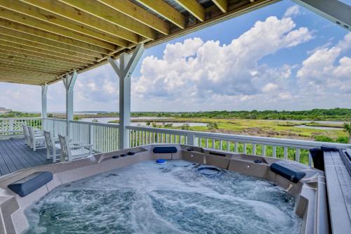 a hot tub on the deck of a house at Sea Haven by Sea Scape Properties in North Topsail Beach