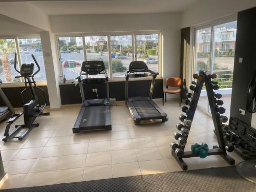 a gym with several treadmills and machines in a room at Sunset View Penthouse Apartment 2 Bedrooms Tatlisu in Akanthou