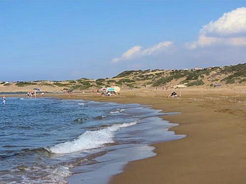 a beach with people on the sand and the water at Sunset View Penthouse Apartment 2 Bedrooms Tatlisu in Akanthou