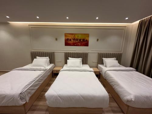 a row of beds in a room at Radiant Pyramids View in Cairo