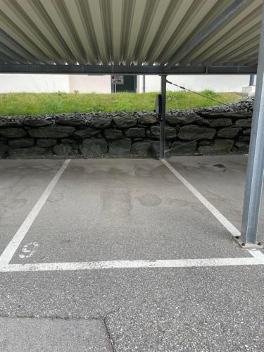 an empty parking lot with a stone wall at Apartment RELAX Bad Kleinkirchheim in Wiedweg