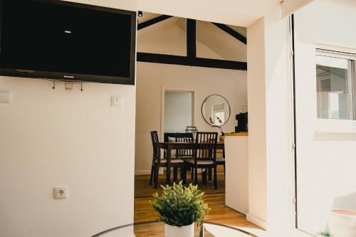 a living room and dining room with a flat screen tv at Casa da Vira - Alojamento Local in Arcos de Valdevez