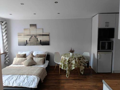 a bedroom with a bed and a table in it at apartament 30 m2 FOR YOU in Szczawno-Zdrój