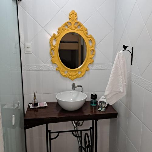 bagno con lavandino e specchio a parete di Suíte próximo a Vila Germânica a Blumenau