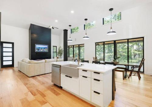 a kitchen and living room with a couch and a table at Whispering Waters in Winchester