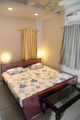 a bedroom with a bed with a glass table on it at Shoreline Marari Beach Villa At Golden Beach Mararikulam in Alleppey