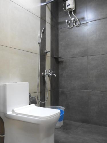 a bathroom with a shower with a toilet and a sink at Shoreline Marari Beach Villa At Golden Beach Mararikulam in Alleppey