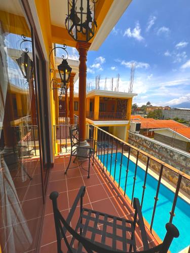 a balcony with a view of a swimming pool at Hotel Jotam in Panajachel