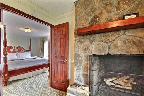 a room with a fireplace and a bedroom with a bed at The Dillard House in Dillard