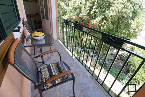 a balcony with a chair and a table with bananas on it at LILY's Peaceful Oasis- BRAND NEW in Korita