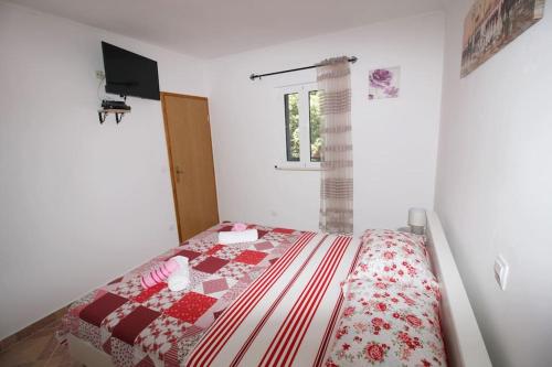 a bedroom with a bed with a red and white quilt at LILY's Peaceful Oasis- BRAND NEW in Korita
