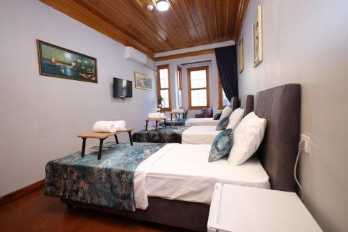 a room with four beds in a room at The Trip istanbul Hotel in Istanbul