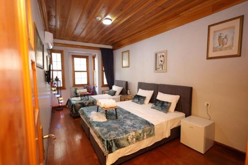 a bedroom with two beds and a couch at The Trip istanbul Hotel in Istanbul