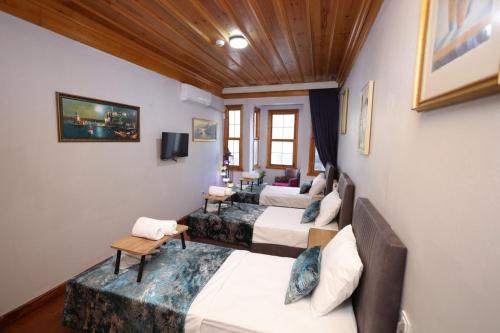 a room with four beds and a couch at The Trip istanbul Hotel in Istanbul
