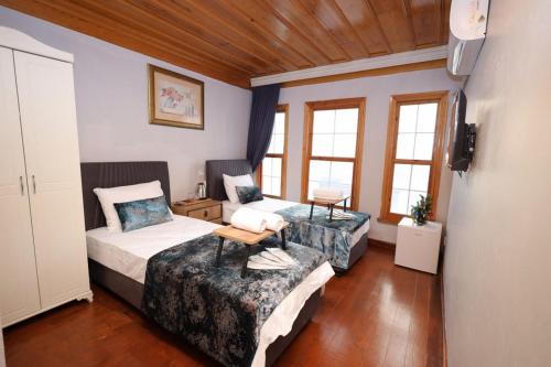 a bedroom with two beds and a couch at The Trip istanbul Hotel in Istanbul