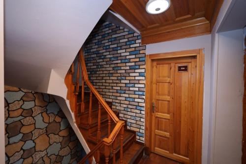 a staircase in a house with a brick wall at The Trip istanbul Hotel in Istanbul