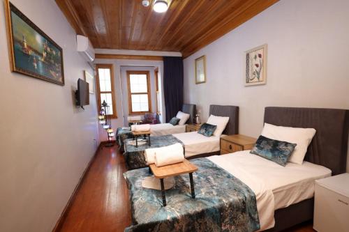 a room with two beds and a couch at The Trip istanbul Hotel in Istanbul