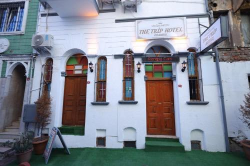 a white building with colorful doors and a sign on it at The Trip istanbul Hotel in Istanbul