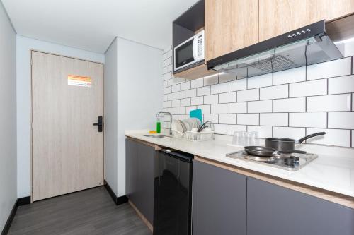 a kitchen with a sink and a stove at Terrazas in Bogotá