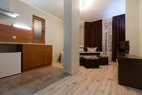 a large room with a living room with a television at Family Hotel Relaxa in Sapareva Banya