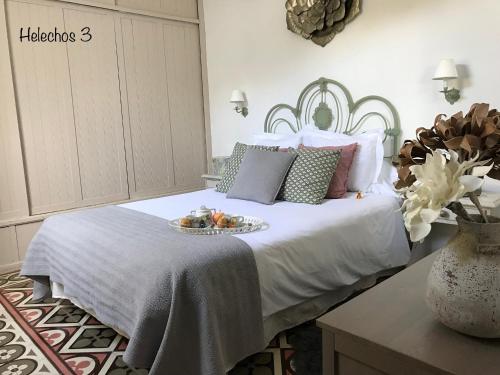 a bedroom with a bed with a tray of fruit on it at Emblemática Los Helechos in Los Realejos