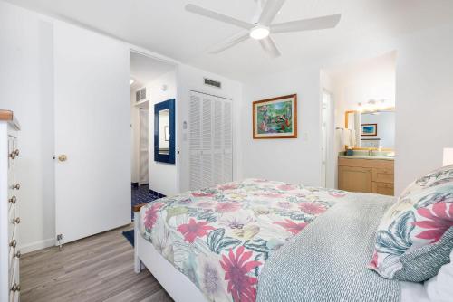 a bedroom with a bed and a ceiling fan at Kona Alii 602 in Kailua-Kona