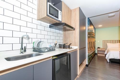 a kitchen with a sink and a microwave at Terrazas in Bogotá