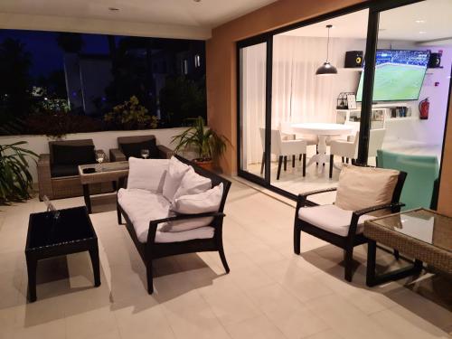a living room with a couch and chairs and a table at Hotel Alcaide in Portimão