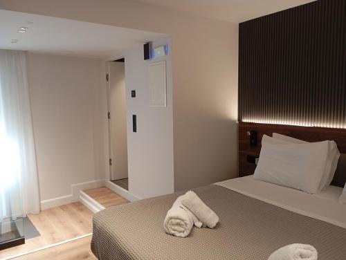 a bedroom with a bed with towels on it at Kantoni Suites in Corfu Town