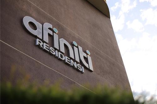 a sign on the side of a building at Afiniti 2BR Sunlit Designer - 3 Min To Legoland in Iskandar Puteri