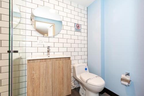 a bathroom with a toilet and a sink and a mirror at Terrazas in Bogotá