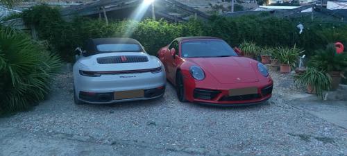 two cars parked next to each other in a driveway at DREAM HOUSE Casa Vacanze in Arma di Taggia