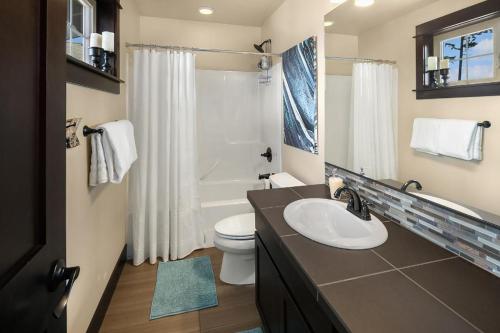 a bathroom with a sink and a toilet and a shower at Sweet Shop Serenity in Cle Elum