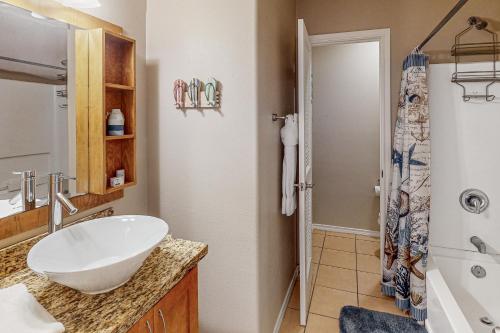a bathroom with a white sink and a shower at Star Beachside Condominiums 106 in South Padre Island